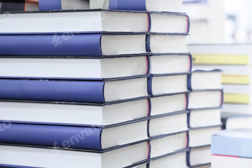 Preview: stack of books on the table. open book