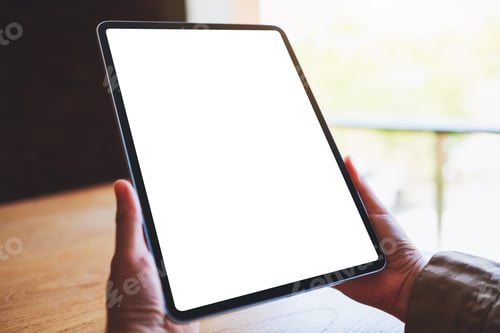 Preview: Mockup image of a woman holding black tablet pc with blank white screen on wooden table