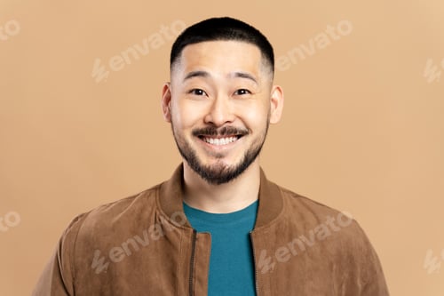 Preview: Smiling asian man with stylish beard, hairstyle wearing brown jacket isolated on beige background