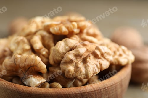 Preview: Peeled walnuts in bowl on table, closeup