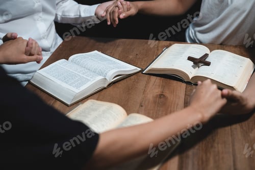 Preview: Asian men and women hands praying to god with the bible.