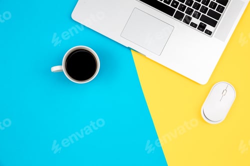 Preview: Laptop, computer mouse and cup of coffee on a yellow and blue background.