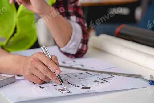Preview: concept architect Engineers are calculating and Holding a pen, pointing to a document showing the ar