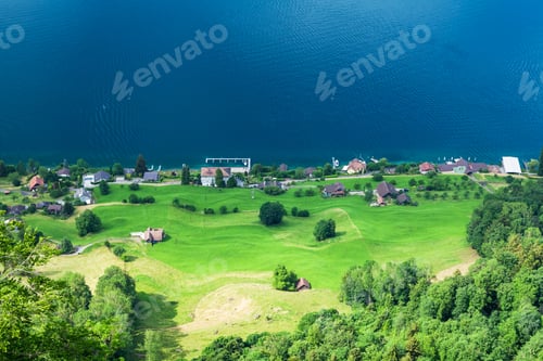 Preview: Panoramic view of lake, green alpine meadows and mountains