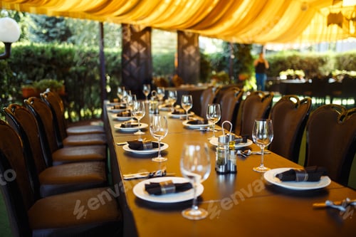 Preview: Sparkling glassware stands on long table prepared for wedding dinner.