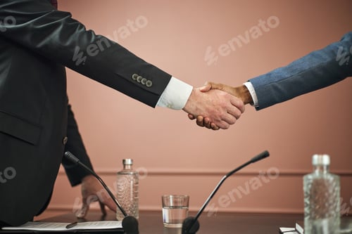 Preview: Middle Aged Caucasian Man and Black Man Shaking Hands during Political Meeting