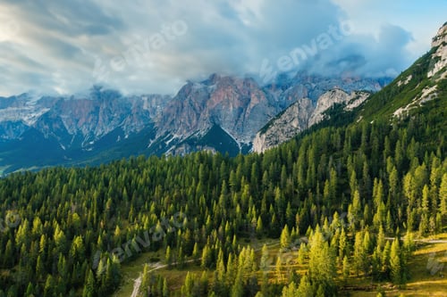 Preview: Giant forestry mountains with bare rocky peaks at sunset