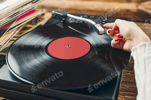 Preview: Woman playing music from vinyl record. Analog record. Retro and vintage style. Analog sound. Music