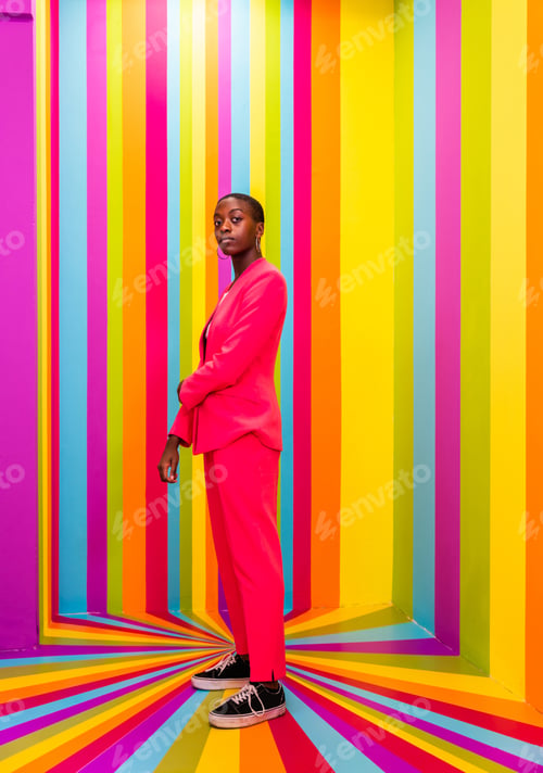 Preview: Beautiful young woman dancing and having fun inside a rainbow box room