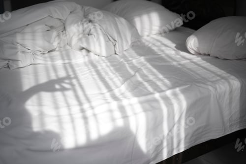 Preview: On a bed in a light bedroom the rays of the sun fall. reflection of curtains moving