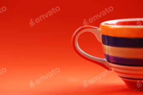 Preview: Colorful cup in orange background
