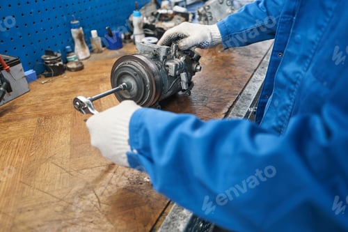 Preview: Close-up photo of mechanic holding tool and car conditioner