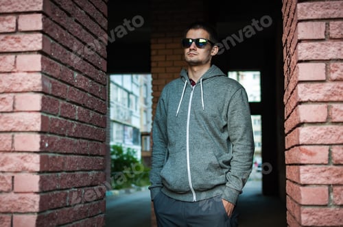 Preview: Portrait of a young man with glasses on the street