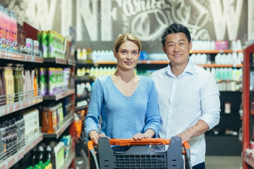 Preview: Portrait of happy shoppers in supermarket, interracial couple Asian man and woman