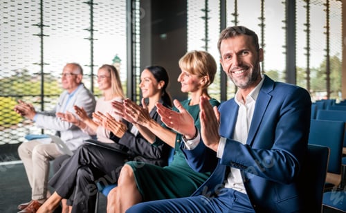 Preview: Happy audience applauding speaker at business conference