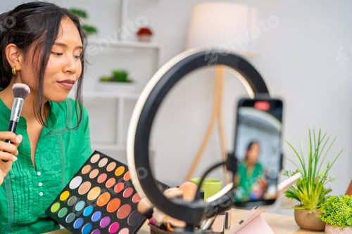 Preview: Influencer creating makeup tutorial video using ring light and smartphone