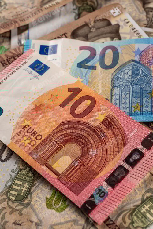 Preview: Pile of Euro and Forint Currency Banknotes