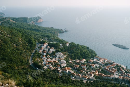 Preview: Aerial view of red tiled roofs of houses of a seaside town at the foot of the mountains