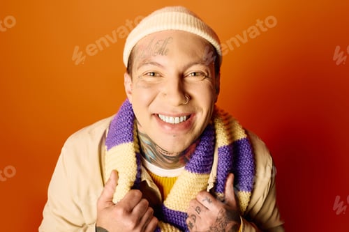 Preview: A young man with tattoos smiles warmly, showcasing his vibrant personality against a bright backdrop