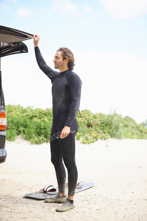 Preview: Kite surfer in wetsuit by car boot, Hornbæk, Hovedstaden, Denmark