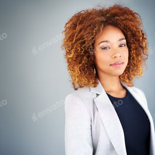 Preview: Full of self confidence. Studio portrait of a young businesswoman against a gray background.