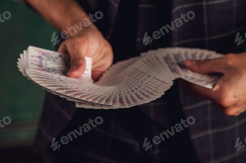 Preview: Close-up portrait of young man with gambling cards