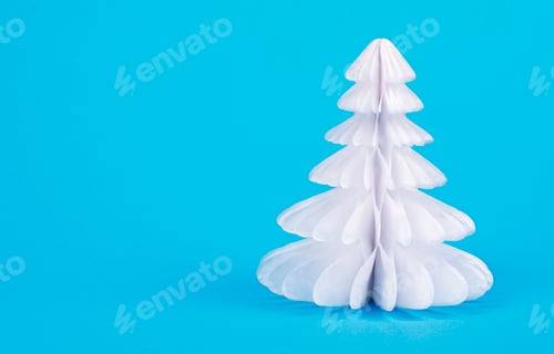 Minimalist White Christmas Tree Decoration on Blue Background