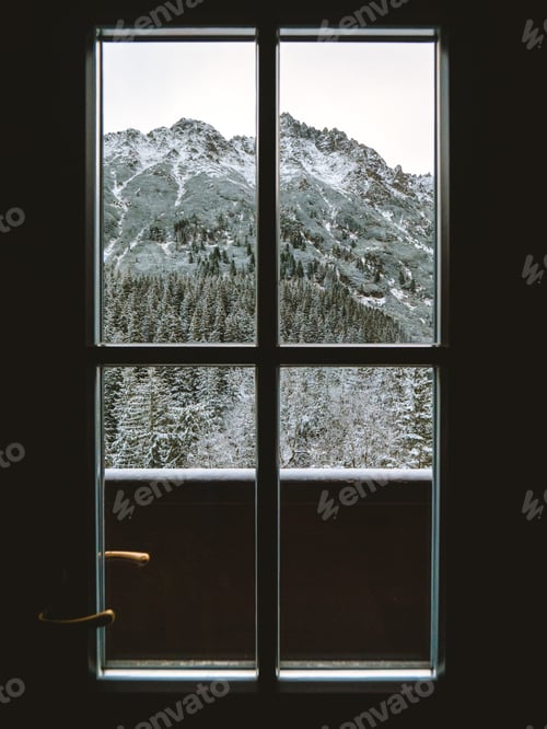 Preview: Vertical shot of a window with the snow capped Tatra mountains in view
