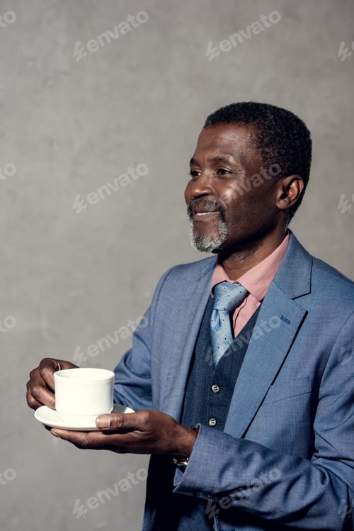 Preview: mature smiling african american man with cup of coffee