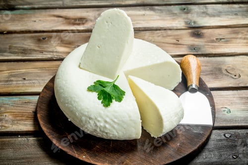 Preview: Soft cheese with mint leaves.