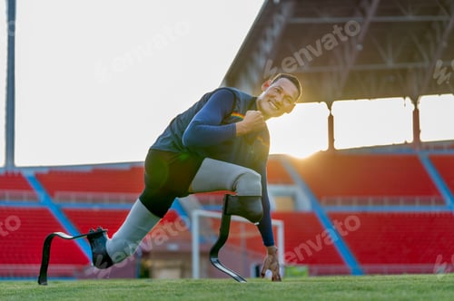 Preview: Close up side view sport man athlete prosthesis legs stay in the position of stretching look camera