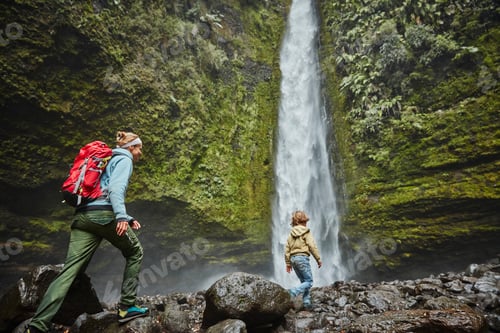 Preview: Chile, Patagonia, Osorno Volcano, mother and son walking at Las Cascadas waterfall