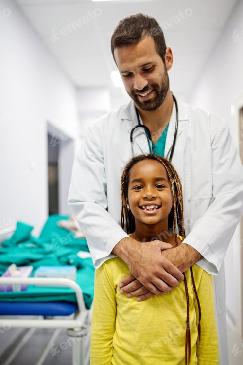 Preview: Pediatrician doctor smiling with his little girl patient at hospital