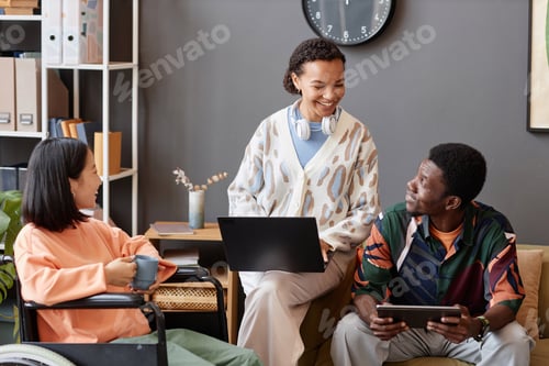 Preview: Multi ethnic group of smiling young professionals in office