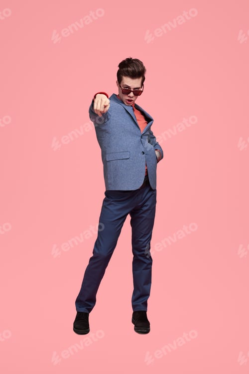 Preview: Trendy young guy pointing at camera