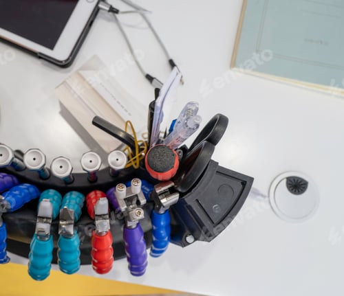 Preview: A set of various and colorful tools for fixing glasses on a workbench. High angle.