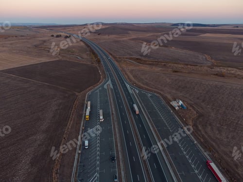 Preview: Aerial view of highway road at sunset in autumn. Top view from drone of road