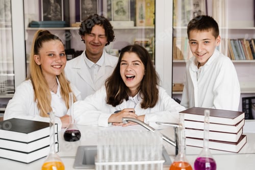 Preview: Happy students hold flasks during school chemistry lesson