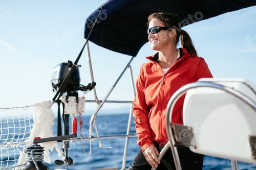 Preview: Attractive strong woman sailing with her boat