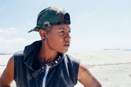 Preview: Portrait of woman wearing basketball cap looking away