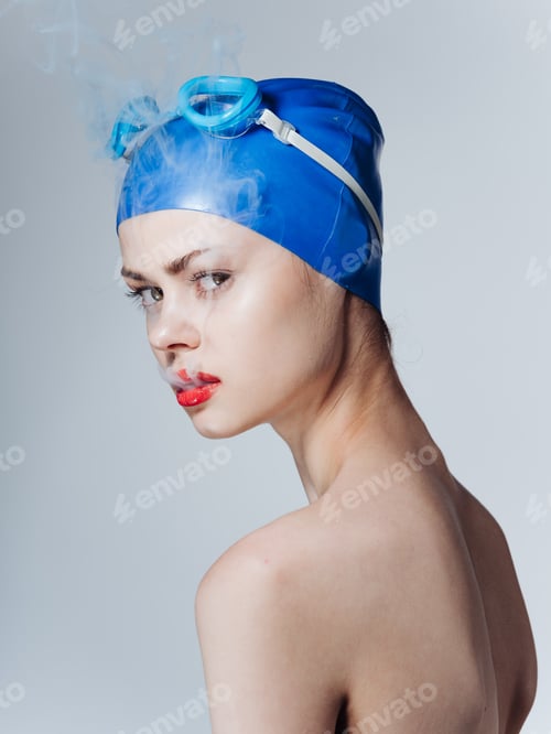 Preview: Smoking woman swimmer in a blue cap and Smoke from the mouth
