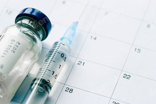 Preview: The vial with vaccine and syringe on calendar