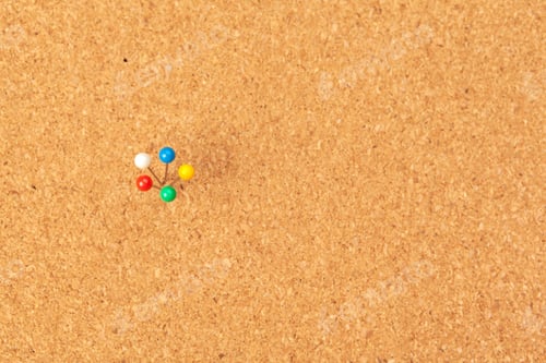 Preview: Group of thumbtacks pinned on corkboard