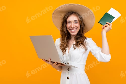 Preview: portrait of emotional girl on an orange background, holding a laptop and passport with tickets
