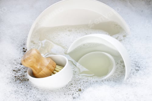 Preview: Washing dishes. Soapy sink filled with dishes and scrub brush.
