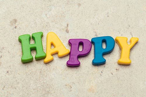 Preview: Word Happy written in colorful plastic letters close up shot