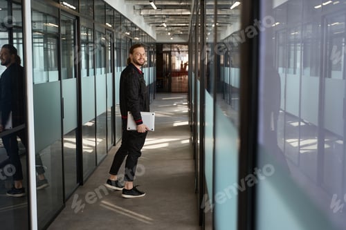 Preview: Happy man looking at camera in hallway