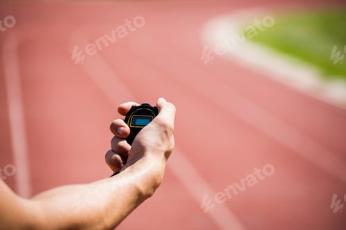 Preview: Hand Holding Stopwatch on a Running Track