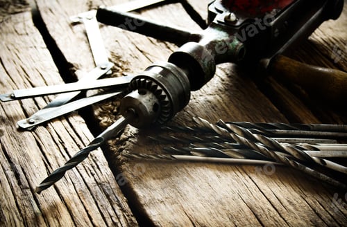 Preview: Old drill, ruler and drills on wooden background.