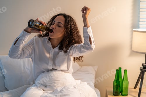 Preview: Drunk Latino woman hold beer bottle, feel hangover and dancing on bed in dark night